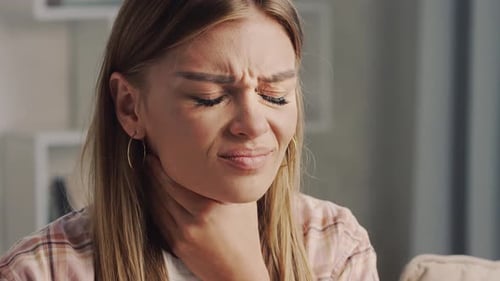 Adult Woman Holding Sore Throat Indoors