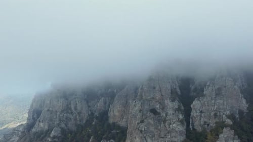 Aerial Footage Above a Foggy Mountain During Fall Season
