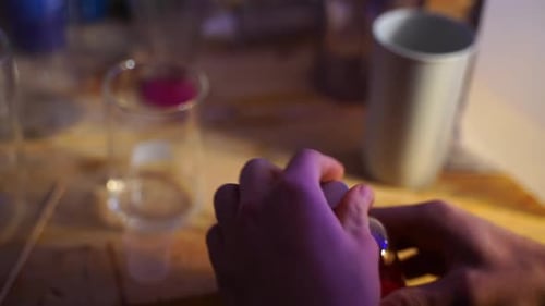 Person Pouring Red Liquid in Lab Experiment