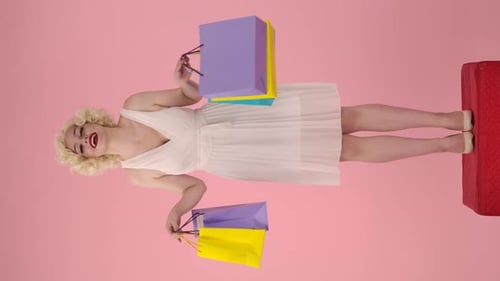 Woman Posing with Shopping Bags on Pink Backdrop