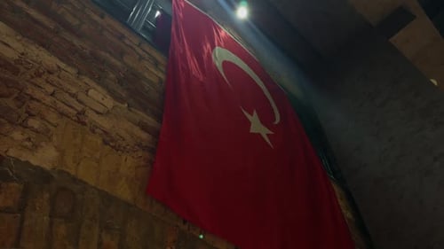 Turkish Flag Hangs Indoors by Old Brick Wall