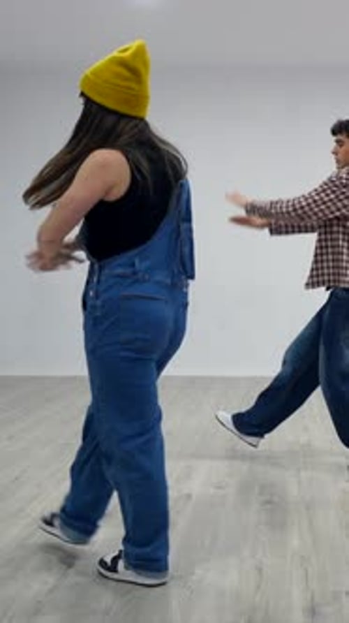 Energetic dancers performing choreography in dance studio
