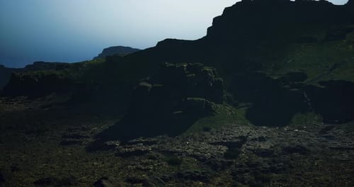 Rugged Terrain Illuminated By Soft Sunlight Over Rocky Landscape at Dusk
