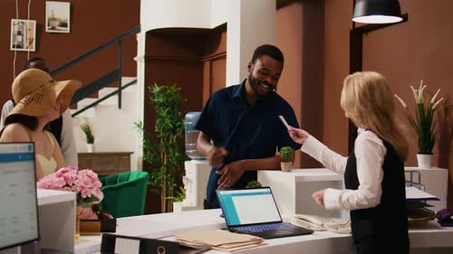 Diverse Couple Checking in at Hotel