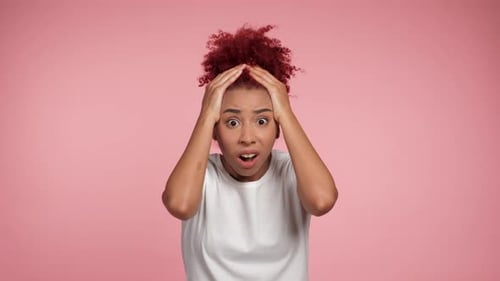 Woman Reacting with Hands on Head in Studio