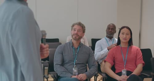 Adults Applaud Speaker at Corporate Conference