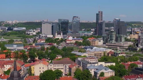 Drone Flies Away from Modern Vilnius Skyscraper Buildings, Reveals Cathedral, Bell Tower