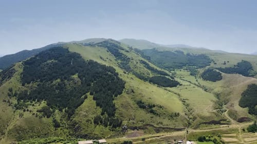 Aerial video view from drone on natural landscape mountain pass under blue sky and clouds. Rural co