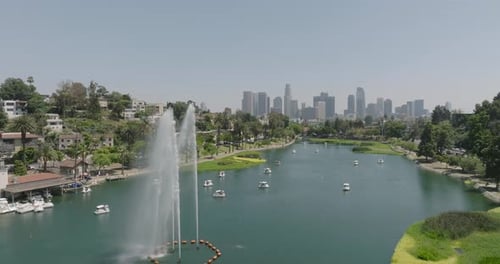 a body of water with trees and buildings in the background