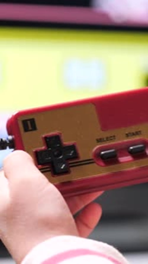 Vertical Video Boy Playing Retro Video Games Holding Joystick Controller at Home