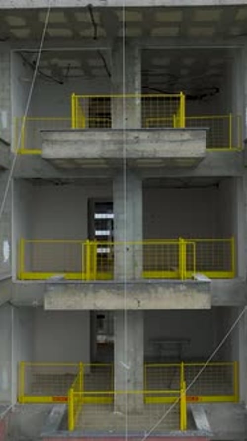 Vertical Aerial View Construction Building Interior with Yellow Safety Railings