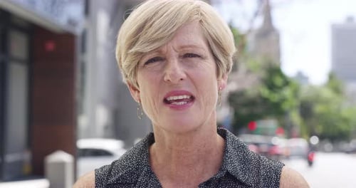 4k video footage of a mature woman being interviewed about her internet speed on the street