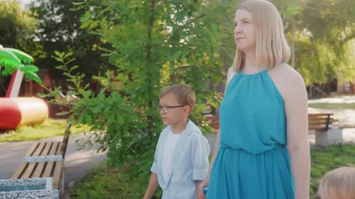 Mother and Son Enjoying Outdoor Fun Casual Family Moment in Sunny Park Setting Father and Child