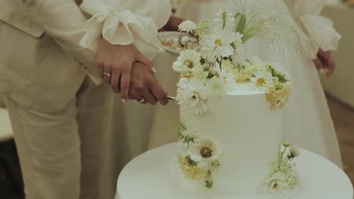 Couple Cutting Wedding Cake at Celebration