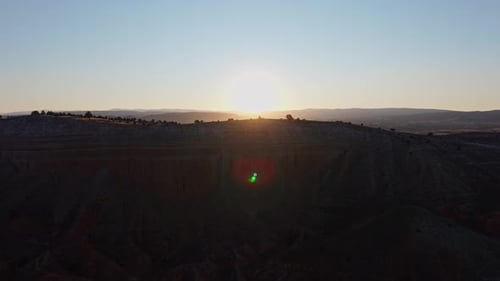 Reveal drone shot over mountain of sunrise and lanscape