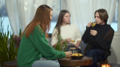Side View of a Happy Relaxed Woman Enjoying Tea and Looking Dreamy Media Blurred Couple