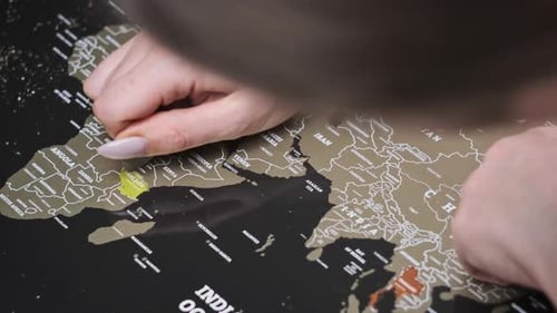 Woman Hand Erases Visited Country of Tanzania on the Travel Map