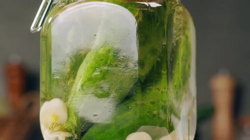 Closeup of Fermented Cucumbers with Garlic in Can Preservation of Vegetables in Glass Jars