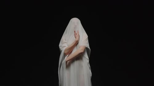 Figure Draped in White Cloth in a Black Void