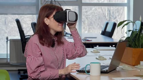 Woman Uses VR Headset in Modern Office