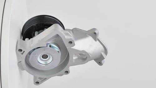 Silver Automotive Water Pump Rotating on White Background