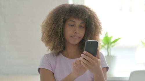 Woman Using Smartphone Indoors during the Day