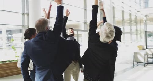 Business Team Celebrates Success in Modern Office