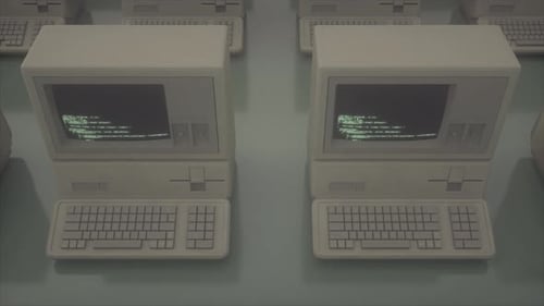 Old Computer Terminals Showing Programming Code on CRT Monitors