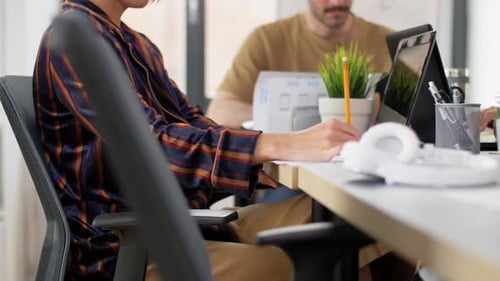 Colleagues Working Together on Laptops in Bright Office