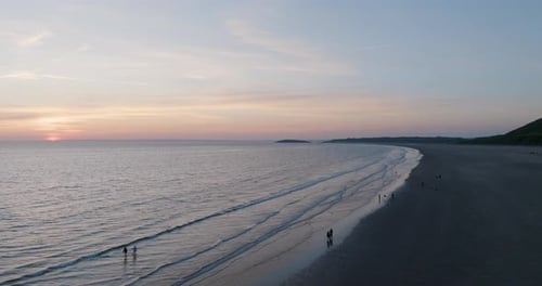 People On The Beach Children In The Water And Fishing At Sunset