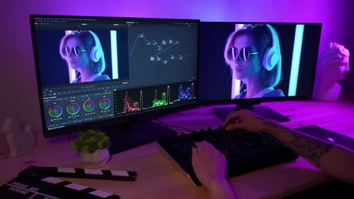 Video Editor Working with Dual Monitors at Desk