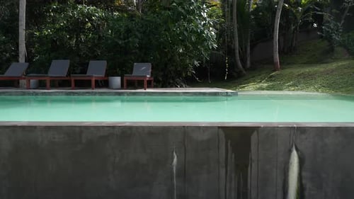 Lounge Chairs At The Poolside Of A Private Resort In Tropical Countryside Of Sri Lanka. Sideways