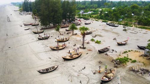 Kuakata Beach, Bangladesh With Fishermen Repairing Fish Nets Near Wooden Boats. Aerial Ascending Sho