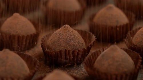 Close Up of Zoom of Truffle Chocolate Candies are Sprinkled with Cocoa Powder