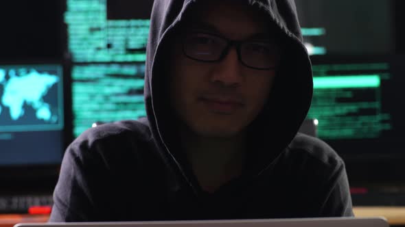 Close Up Of Hacker In A Hood Looking At Camera And Crossing His Arms ...