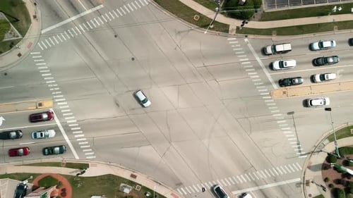 Wide Aerial Shot of Cars Driving Cars Move Along the Intersection of Roads Above Shot