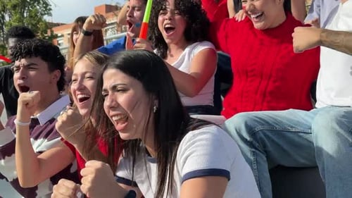 Excited Sports Fans Cheering for Their Team in Stadium
