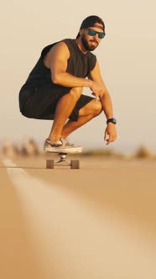 Adult Attractive Bearded Man Skateboarding on the Street