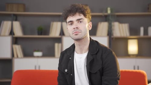 Young Adult Sitting on Orange Couch