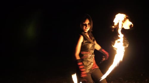 Woman Performing Fire Dance at Night