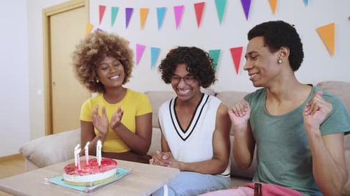 Friends Celebrate Birthday with Cake and Candles