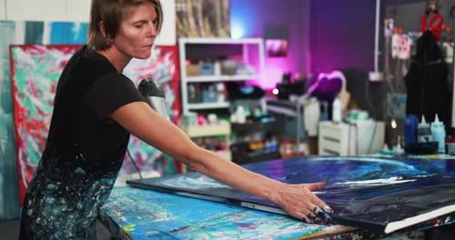 Mature Caucasian Woman Painting Inside Her Atelier Studio at Home Activity