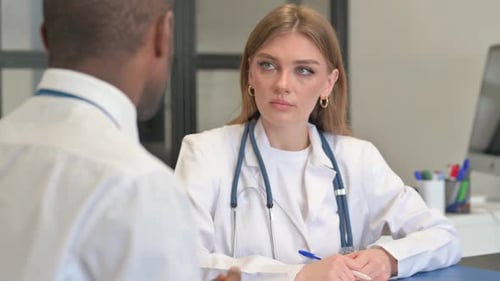 Close up of Female Doctor Talking with African Male Patient