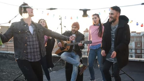 Friends Enjoying Music on a Rooftop Celebration