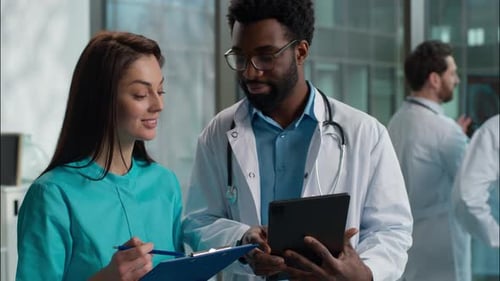 Medical Professionals Collaborating with Tablet in Hospital