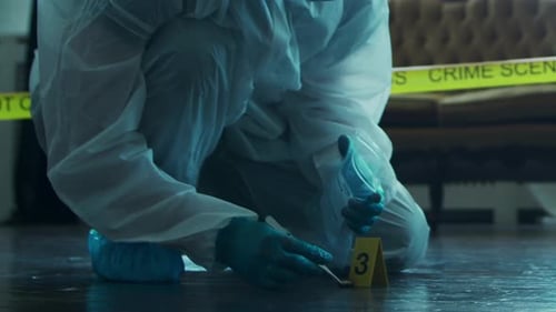 Forensic Scientist Collects Evidence at Crime Scene