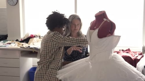Female Fashion Designers Discussing White Tutu on Dressmakers Model Adult
