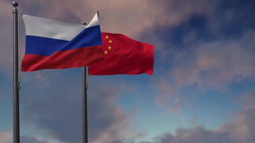 Russia and China Flags Waving Together Against a Cloudy Sky