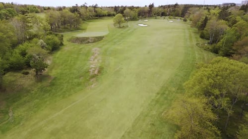 Aerial Shot Of Golf Course With Players And Groundskeeping Staff At Work