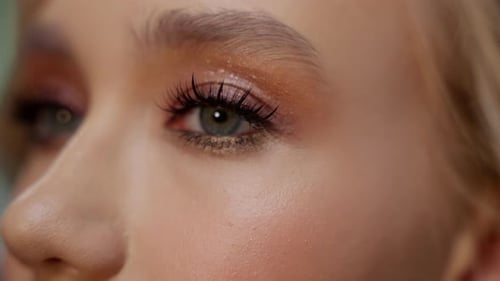Closeup on a Model's Eye Makeup and Glossy Lips Showcasing Makeup Artistry Detailed Eye Makeup and
